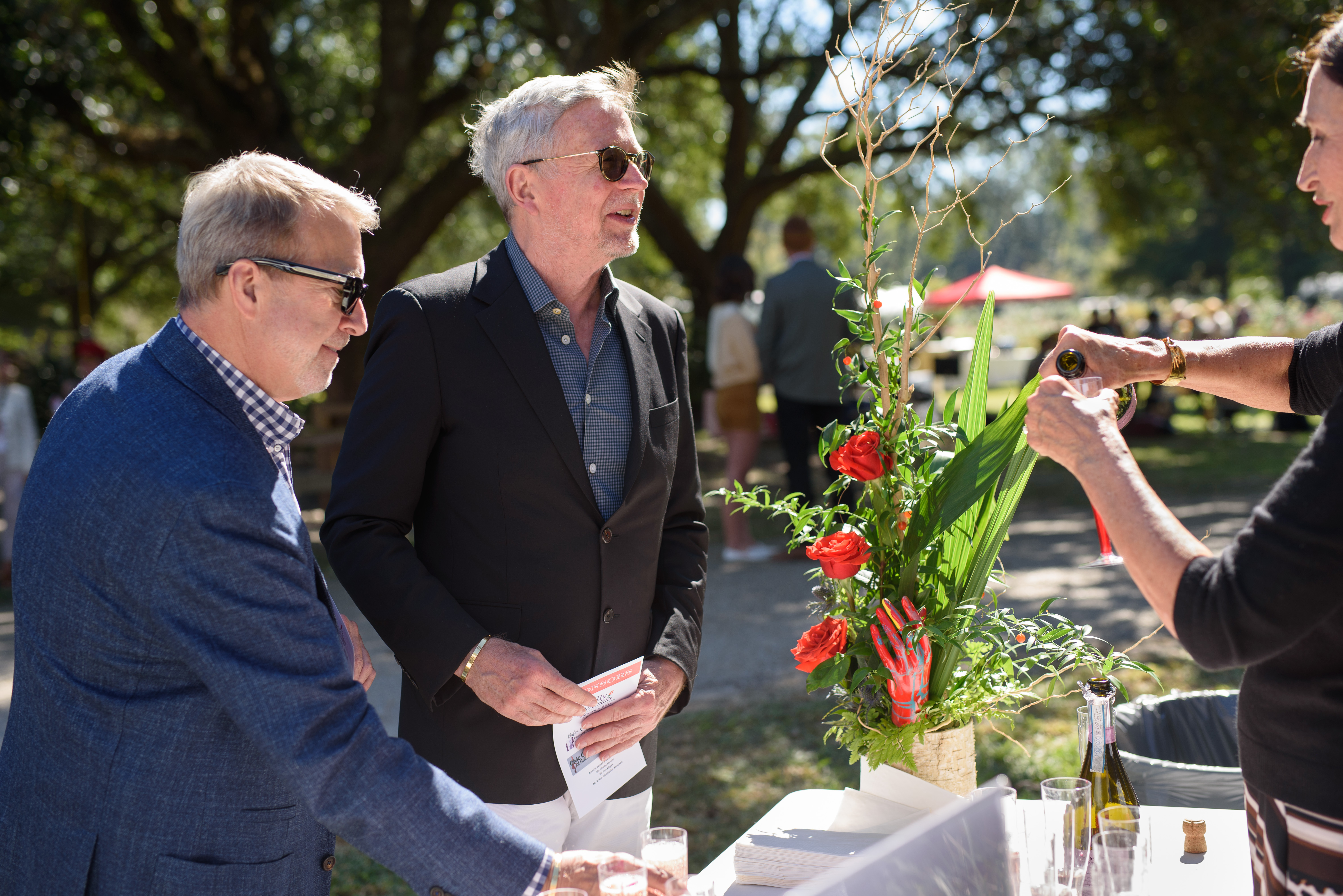 Men looking at roses.